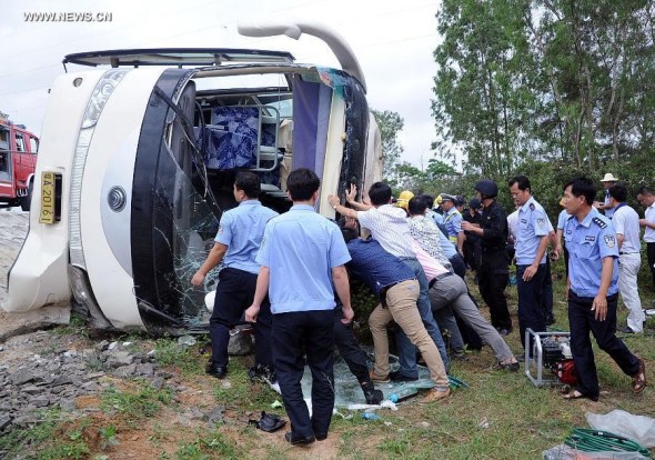 Rescuers work at the accident site after a bus for spring-outing overturned in Dongge township of Wenchang City, south China's Hainan Province, April 10, 2014. Eight pupils died and more than 10 others were injured after their bus overturned here Thursday morning. The accident happened at about 11am when the children were on a bus for a school-organized outing. (Xinhua) 