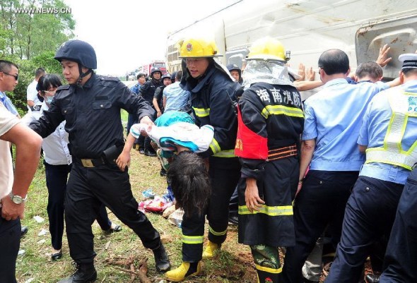 Rescuers work at the accident site after a bus for spring-outing overturned in Dongge township of Wenchang City, south China's Hainan Province, April 10, 2014. Eight pupils died and more than 10 others were injured after their bus overturned here Thursday morning. The accident happened at about 11 am when the children were on a bus for a school-organized outing. (Xinhua)
