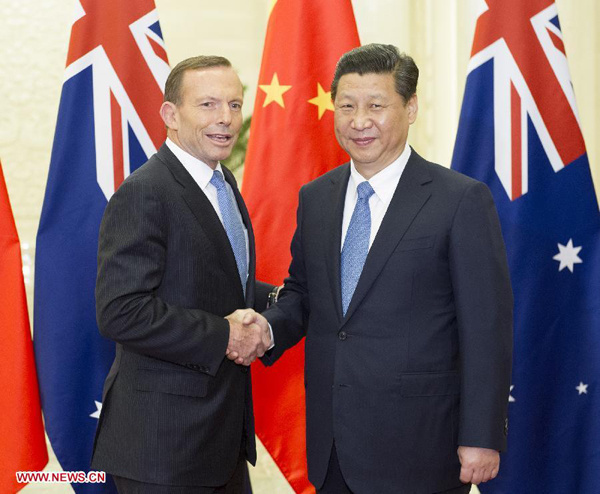 Chinese President Xi Jinping (R) meets with visiting Australian Prime Minister Tony Abbott at the Great Hall of the People in Beijing, capital of China, April 11, 2014. (Xinhua/Huang Jingwen)
