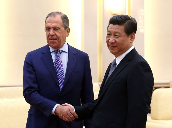 President Xi Jinping greets Russian Foreign Minister Sergey Lavrov in the Great Hall of the People in Beijing on Tuesday. WU ZHIYI/CHINA DAILY