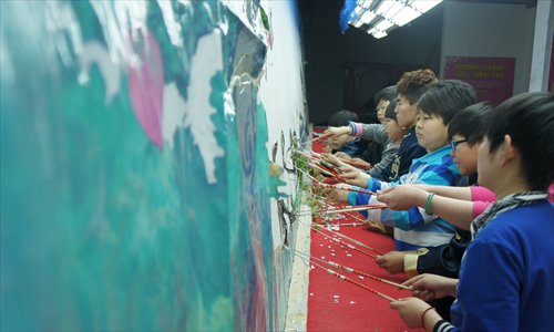 Performers from Longzaitian perform a shadow play in their stationary theater near the south gate of Yuanmingyuan Park in Beijing on April 9. Photo: Huang Jingjing/GT