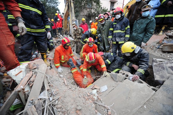 This 2012 photo shows rescue teams work to save residents of a collapsed six-story building in Ningbo, Zhejiang province. Yan Jie / For China Daily 