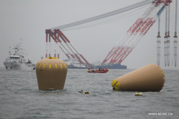 Air bags can be seen near the capsized ferry in Jindo on April 18, 2014. South Korean coast guard and navy divers will seek to enter into the hull of the sunken South Korean passenger ferry for three hours late Friday after failing to make their way into passenger cabins earlier. (Xinhua/Song Cheng Feng)