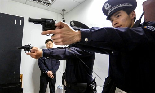 Officers check their revolvers before going on a patrol. Photo: Yang Hui/GT 