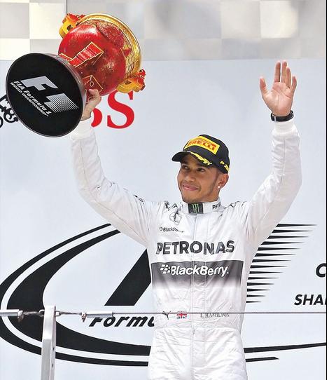 Mercedes F1 driver Lewis Hamilton waves to the fans after capturing his third straight Formula One race, leading from start to finish to win the Chinese Grand Prix in Shanghai yesterday. His teammate Nico Rosberg finished second. (Photo: Shanghai Daily)