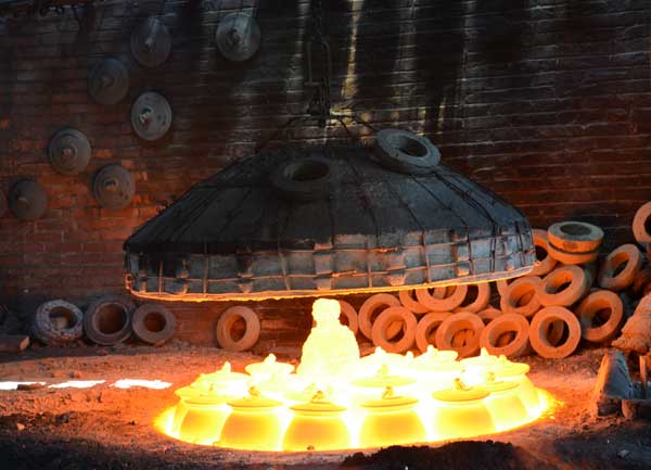 Pottery pieces are revealed after the 1,500 C firing process in a traditional kiln about 2 meters in diameter in Yingjing county, Sichuan province, on April 12. In the center is a new statue made by local potter Zeng Qinghong. Peng Chao / China Daily