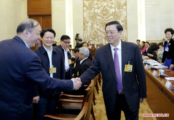 Zhang Dejiang (C), chairman of the Standing Committee of China's National People's Congress (NPC), participates in the deliberation on draft revisions to China's Environmental Protection Law during the eighth session of the 12th NPC Standing Committee in Beijing, capital of China, April 22, 2014. (Xinhua/Zhang Duo)