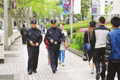 Police carrying revolvers on patrol are seen Sunday in Shanghai. The Ministry of Public Security invested in the firearms and specially designed them for its police force. [Photo /Xinmin Evening News]