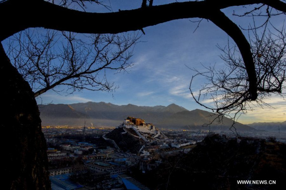 Photo taken on Jan 14, 2014 from the Chakpori Hill shows a view of the Potala Palace at dawn in Lhasa, capital of southwest China's Tibet Autonomous Region.  [Xinhua file photo/ Purbu Zhaxi]