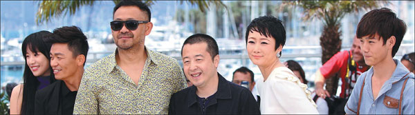 From top: Director Jia Zhangke (fourth from left) with several members of the cast of his new film A Touch of Sin in Cannes, France, and two scenes from the film. Gao Jing/Xinhua
