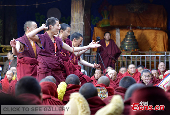 Geshe Lharampa candidates debate with members of the exam board in the annual defense exam to gain the highest degree in Tibetan Buddhism at the Jokhang Temple, Lhasa, on April 3, 2014. 