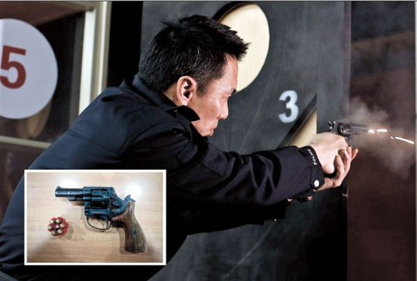 An officer fires a 9mm revolver (inset) during a training session at Changning District police station yesterday. As of Sunday, all officers in the district will carry the weapon as part of a nationwide campaign to enable them to combat violent crime and better deal with emergencies.  Yang Yi 