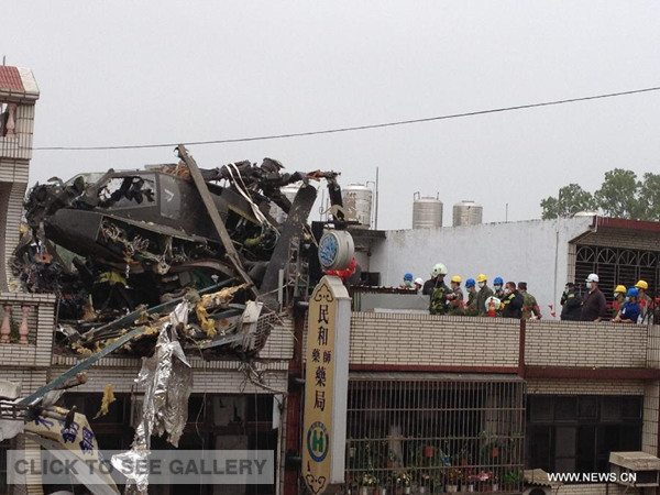 Photo taken with a cellphone on April 25, 2014 shows a military helicopter crashing into a residential builiding in Taoyuan County, southeast China's Taiwan. 