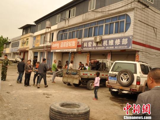 The repair shop where the man works.