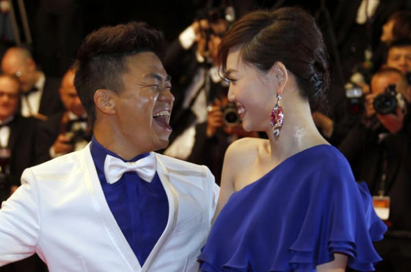 Actor Wang Baoqiang (L)and his wife Ma Rong pose on the red carpet as they arrive for the screening of the film A Touch of Sin during the 66th Cannes Film Festival in Cannes on May 17,2013. Regis Duvignau / Reuters