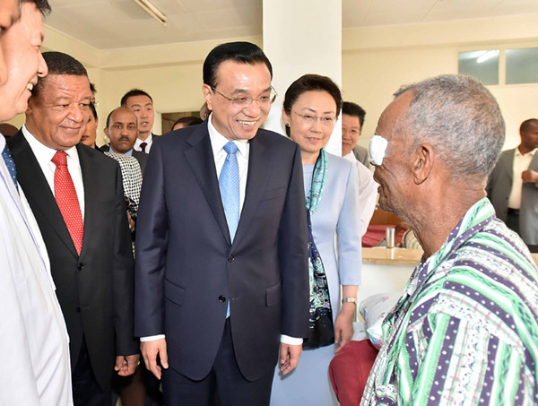 Chinese Premier Li Keqiang and his wife Cheng Hong, accompanied by Ethiopian President Mulatu Teshome and his wife Meaza, visit a cataract patient who has benefited from the Bright Journey medical program at a hospital in Addis Ababa, the capital of Ethiopia, May 6, 2014. [Photo/gov.cn]