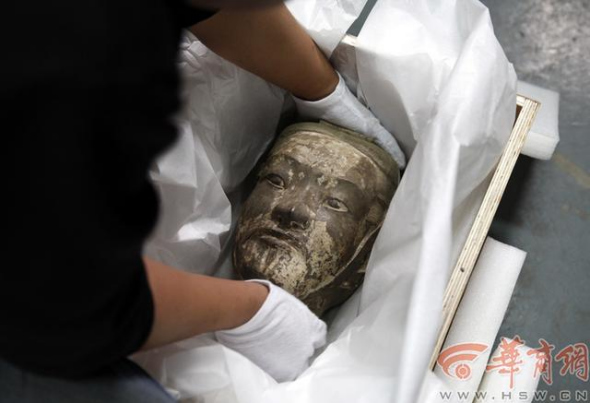 An employee carefully packages a cultural relic in Xi'an, Shaanxi province, April 24, 2014. [Photo/hsw.cn]