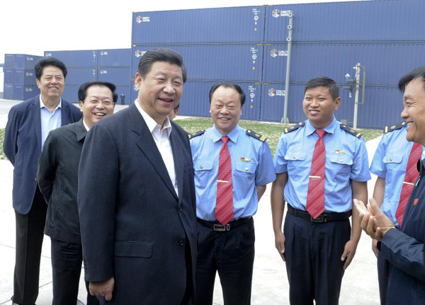 Chinese President Xi Jinping (L front), also general secretary of the Communist Party of China (CPC) Central Committee and chairman of the Central Military Commission, talks with staff members of Zhengzhou-Europe International Block Train at Zhengzhou International Land Port in Zhengzhou, capital of central China's Henan Province, May 10, 2014. Xi made an inspection tour in Henan from May 9 to 10. (Xinhua/Zhang Duo)