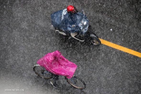 Bikers ride in heavy rain in Shantou, south China's Guangdong province, May 11, 2014. A heavy rainstorm hit the city Sunday. (Xinhua/Yao Jun) 