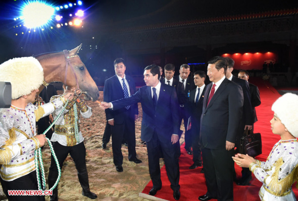Chinese President Xi Jinping (2nd R, front) receives an Akhal-Teke horse presented by his Turkmenistan counterpart Gurbanguly Berdymukhamedov (3rd R, front) during the opening ceremony of the International Akhal-Teke Horses Association Special Conference and China Horse Culture Festival in Beijing, May 12, 2014. (Xinhua/Liu Jiansheng)