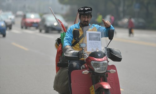 Dolkun rides his motorcycle out of Chenzhou, Hunan province on March 31. Photo: Courtesy of rednet.cn
