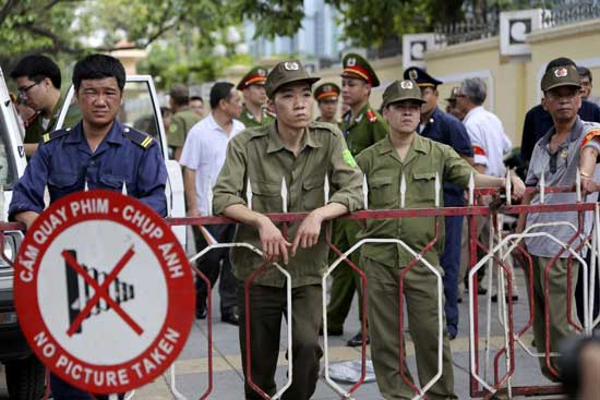 Vietnamese security officers set up a fence outside an area of the Chinese Embassy in Hanoi, Vietnam on Sunday, May 18, 2014.