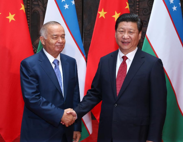 Chinese President Xi Jinping (R) meets with Uzbekistan's President Islam Karimov in Shanghai, east China, May 20, 2014. (Xinhua/Pang Xinglei)