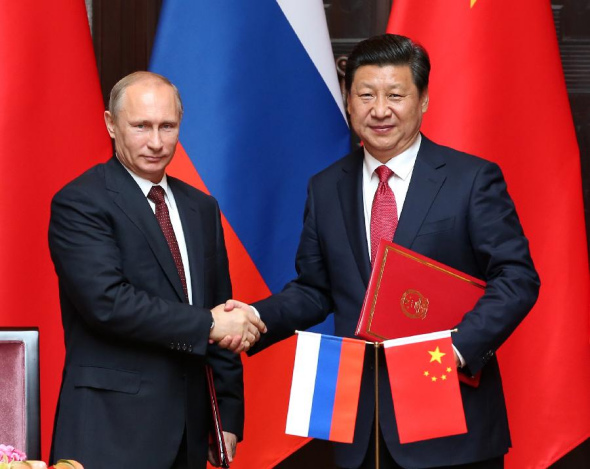 Chinese President Xi Jinping (R) and Russian President Vladimir Putin sign a joint statement aimed at expanding cooperation in all fields and coordinating diplomatic efforts to cement the China-Russia all-round strategic partnership of cooperation after their talks in Shanghai, May 20, 2014. (Xinhua/Pang Xinglei)