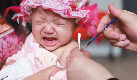 A baby girl receives a routine vaccination jab in Yongnian county, Hebei province. Hu Gaolei / for China Daily