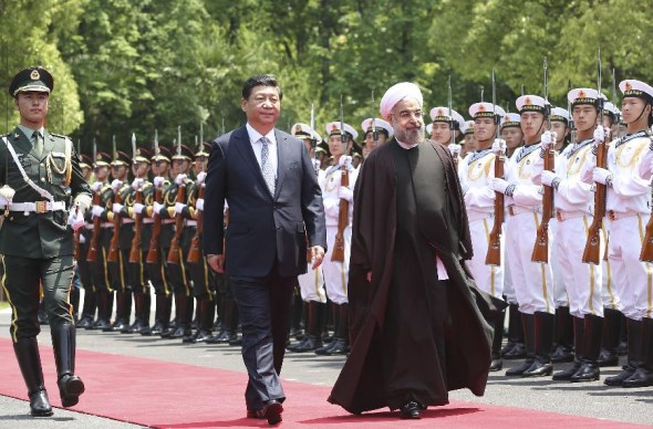 Chinese President Xi Jinping (L, front) and Iranian President Hassan Rouhani (R, front) review the guard of honor at the welcoming ceremony ahead of their talks in Shanghai, east China, May 22, 2014. (Xinhua/Lan Hongguang)