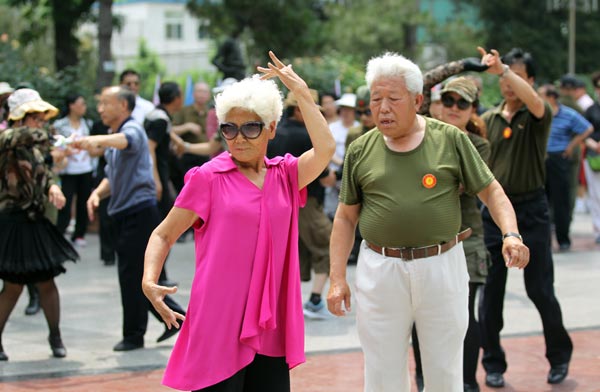 Wang Baorong (left), 71, travels several hours every day to dance at Taoranting Park with other middle-aged and elderly people.