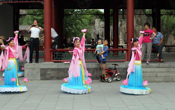 Women, mostly retirees, set up a dance troupe two years ago. They perform a lotus dance at Qishiguan Park in Dongcheng district in Beijing.