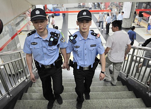 TIGHTENED SECURITY: Two armed police officers patrol a subway station in Beijing on May 23 (LI WEN)