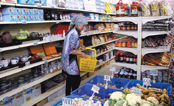 A local woman buys some food in a Chinese-owned store at Yalian market in Almaty, Kazakhstan. The majority of staple goods consumed by Kazakhs are imported from China. Zou Hong / China Daily