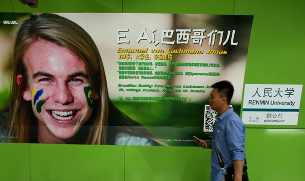 A passenger walks past a post promoting the upcoming World Cup at the Renmin University station on Line 4 of the Beijing subway. [Wang Jing / China Daily]