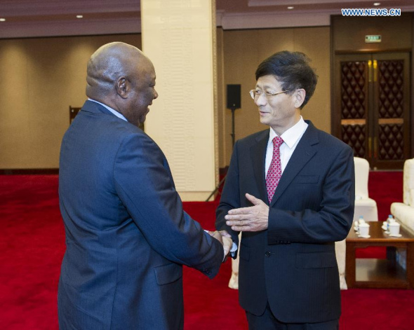 Meng Jianzhu (R), a member of the Political Bureau of the Communist Party of China (CPC) Central Committee and head of the Commission for Political and Legal Affairs of the CPC Central Committee, meets with Tanzanian Minister for Home Affairs Mathias Chikawe in Beijing, capital of China, June 10, 2014. (Xinhua/Wang Ye)