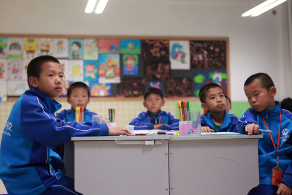Students take an art class at the Evergrande Soccer School in Qingyuan, Guangdong. Soccer schools are now emphasizing the importance of academic studies.