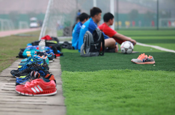 Students take a break after a training session at the Evergrande Soccer School. The school plans to boost student numbers to about 2,300 this year.