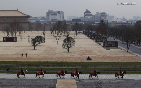 Photo taken on Dec. 7, 2011 shows a horse team passing by the ruins of Hanyuan Hall, once an integral part of the Daming Palace which was built in the Tang Dynasty (618-907). (Xinhua)