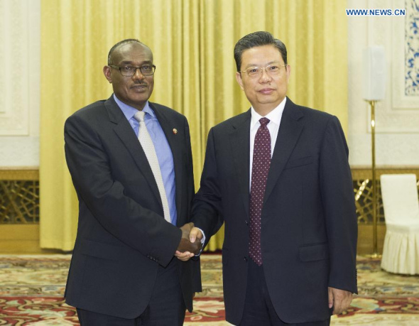 Zhao Leji (R), a member of the Political Bureau of the Communist Party of China (CPC) Central Committee, meets with a delegation from Sudan's National Congress Party (NCP), which is led by Eldirdiry Mohamed Ahmed (L), the NCP's foreign minister, in Beijing, June 23, 2014. [Xinhua/Xie Huanchi]