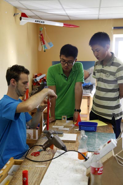 Chinese students observe the making of a rocket model while visiting the Euro Space Center in Belgium during a summer camp in August, 2013. Wang Xiaojun / XinhuaChinese students observe the making of a rocket model while visiting the Euro Space Center in Belgium during a summer camp in August, 2013. Wang Xiaojun / Xinhua