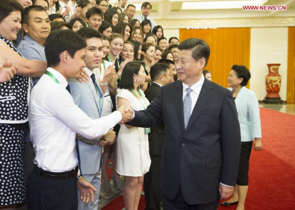 Chinese President Xi Jinping (R, front) meets with a delegation of teachers and students from the Nazarbayev University of Kazakhstan in Beijing, capital of China, June 24, 2014. [Xinhua/Xie Huanchi]