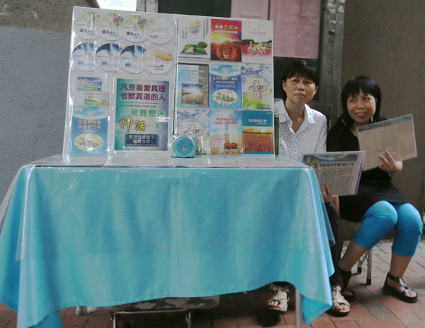 Members of Quannengshen promote the cult on a street in Hong Kong. Critics say the sect's main targets are the elderly, 'left-behind' women, laid-off workers and distraught divorcees. Edmond Tang / China Daily