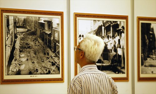 A visitor to the exhibition looks closely at the pictures. Photo: Yang Hui/GT