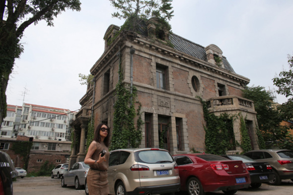 A woman walks past the alleged haunted house - Chaonei Church at No 81 Chaonei Avenue in Beijing's Dongcheng district, owned by the Beijing Patriotic Catholic Association. Wang Jing / China Daily