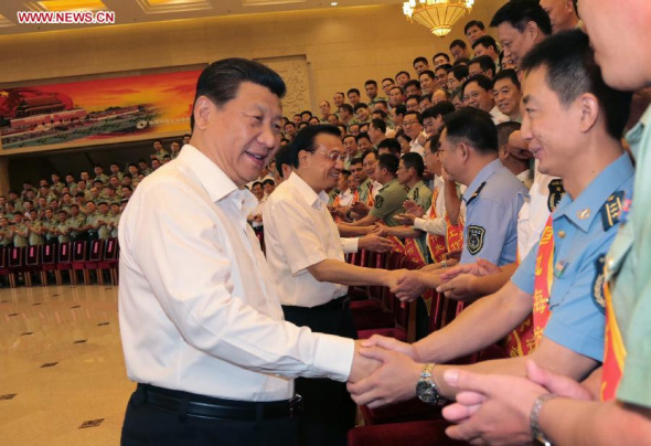 Senior Chinese leaders Xi Jinping, Li Keqiang and Zhang Gaoli meet with representatives attending a national meeting on frontier and coast defense in Beijing, China, June 27, 2014. (Xinhua/Li Gang)