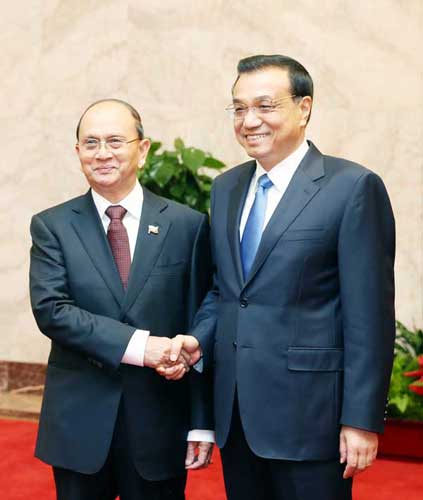 Premier Li Keqiang shakes hands with Myanmar President U Thein Sein during meetings in Beijing, June 28, 2014. [Photo/Xinhua]