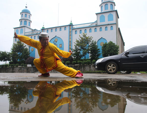 Li Shengjun, 38, practices traditional Hui martial arts in front of the mosque in Zhabu, a township in Central China's Hunan province, where Hui Muslims have lived with Han people in harmony for hundreds of years. Wang Jing / China Daily