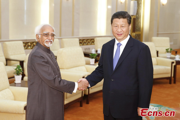 Chinese President Xi Jinping shakes hands with Indian Vice-President Mohammad Hamid Ansari during a meeting at the Great Hall of the People in Beijing, June 30, 2014. [Photo: China News Service/Sheng Jiapeng]
