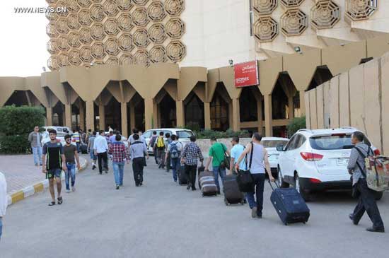 Chinese workers arrive at a hotel in Baghdad, Iraq, on June 28, 2014. (Xinhua/Shang Le)
